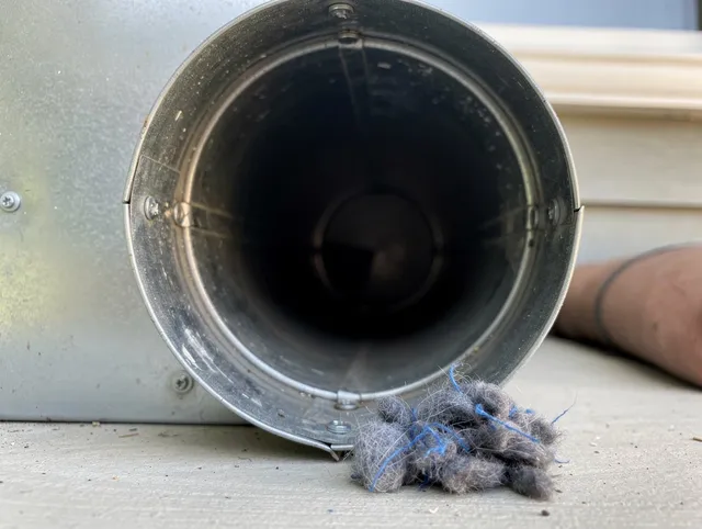 Holliston Dryer Vent Cleaning technician using specialized equipment to clear severe dryer vent blockage in Holliston